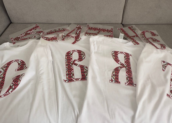 White t-shirts with red text and dtf prints